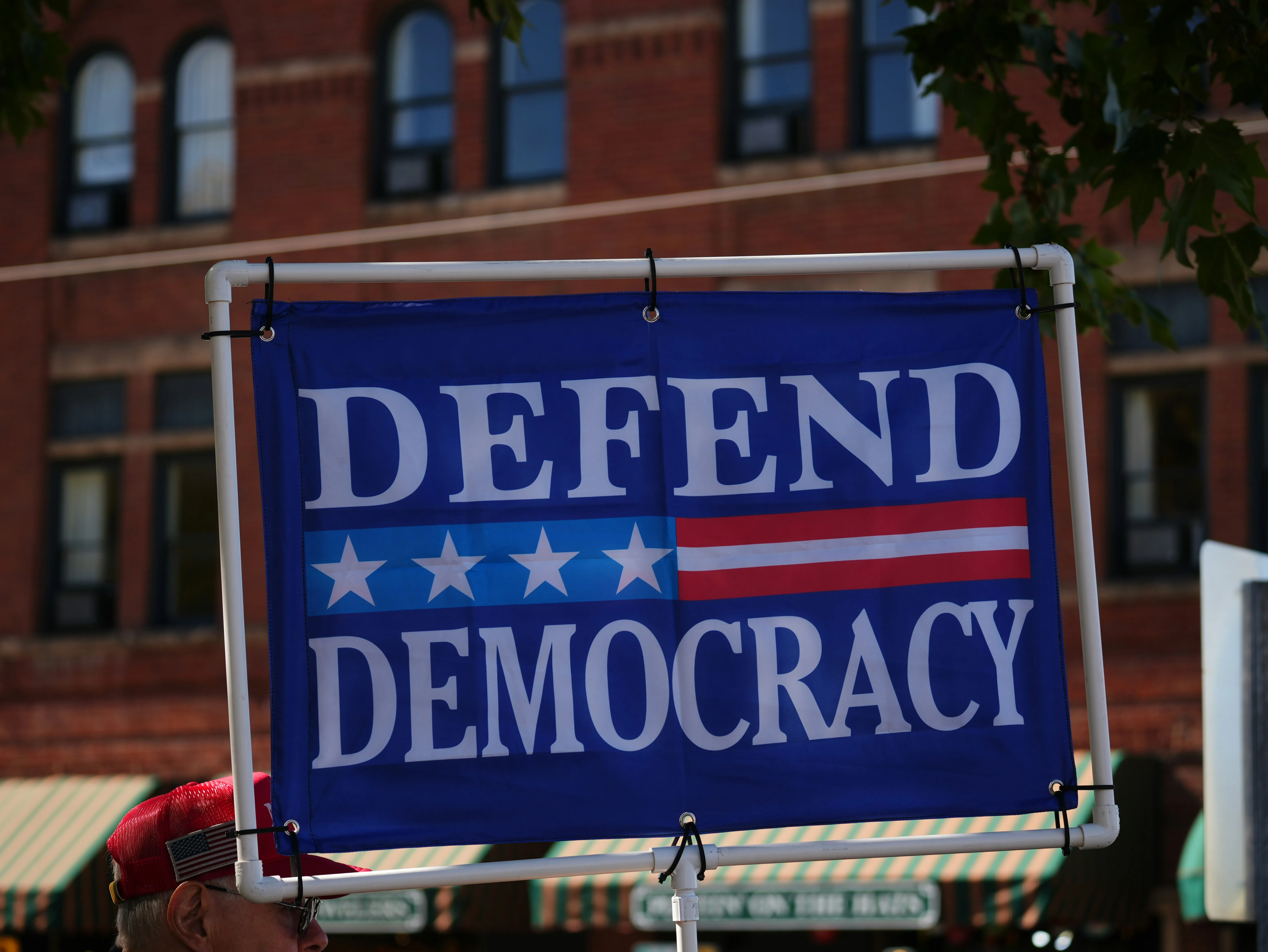 A sign saying defend democracy